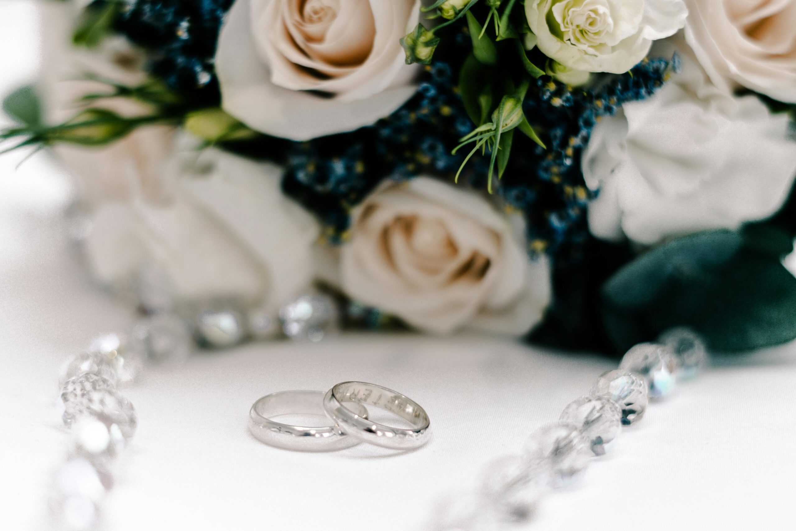 pexels-photo-30655486-30655486 Close-up of wedding rings and a beautiful floral bouquet, perfect for romance and wedding themes.
